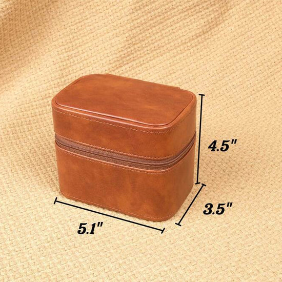 Brown leather jewelry box with dimensions on a beige fabric background