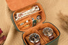 Open jewelry case with watches and accessories on a beige background