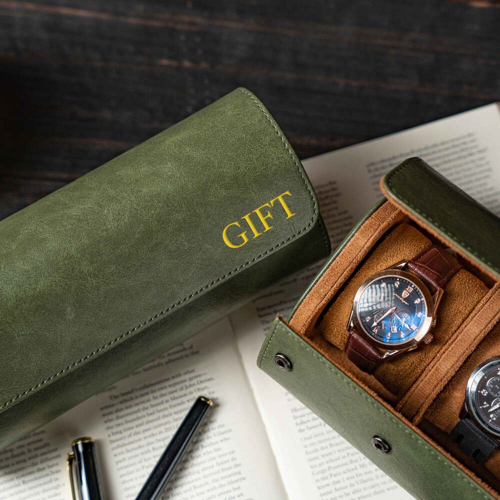 Green gift pouch with 'GIFT' text and a watch in a box on an open book.