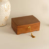Two-tier wooden jewelry box with a lock and a brown velvet lining, displayed against a neutral background.
