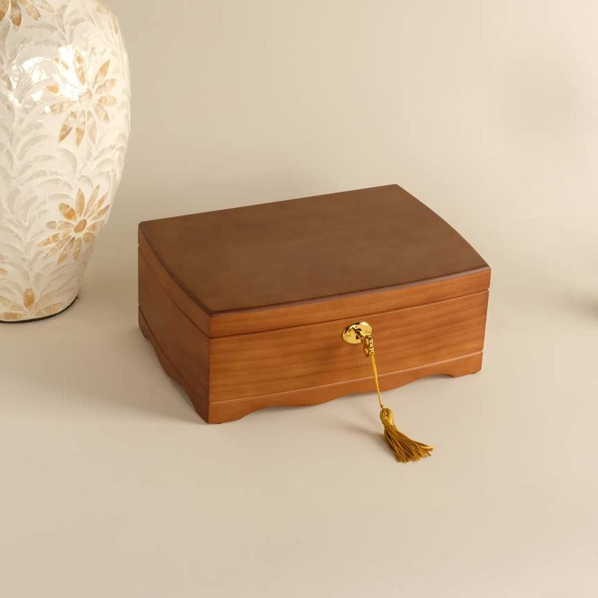 Two-tier wooden jewelry box with a lock and a brown velvet lining, displayed against a neutral background.